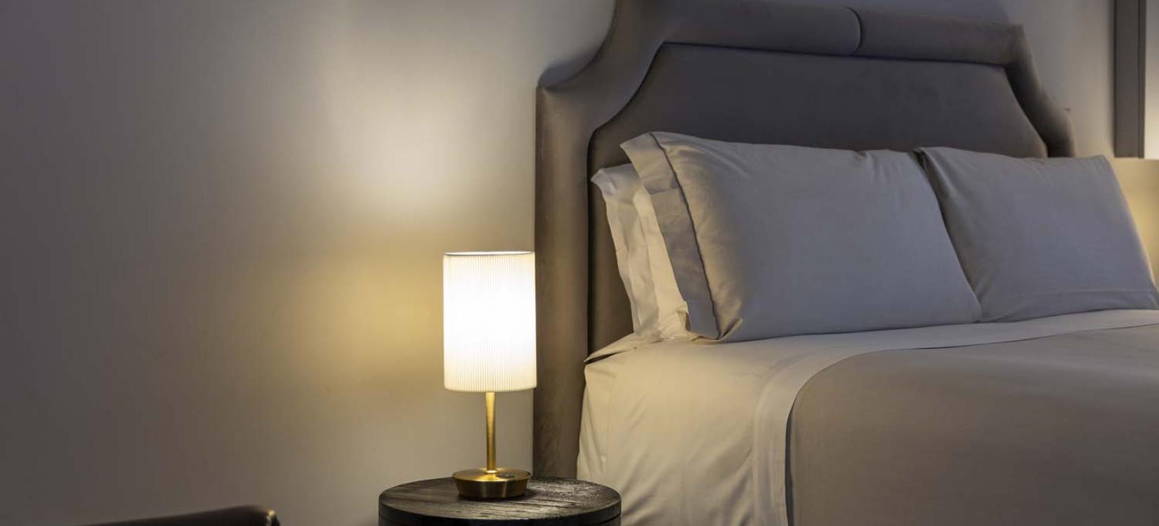 Cozy room with elegant bed and soft lighting, creating a relaxing atmosphere.